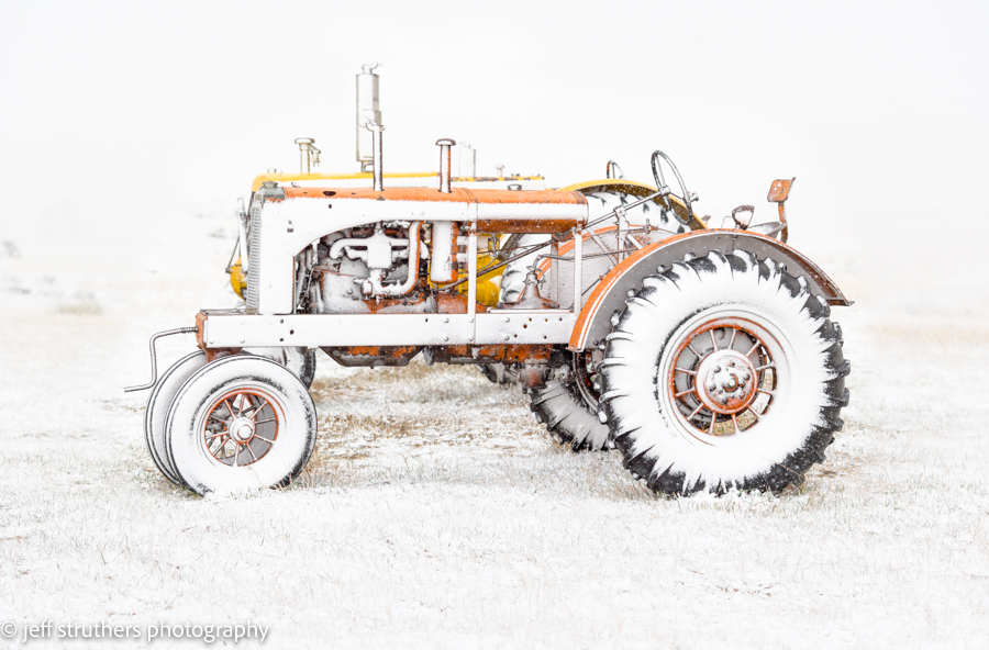 A tractor with snow tires on the front and rear wheels.