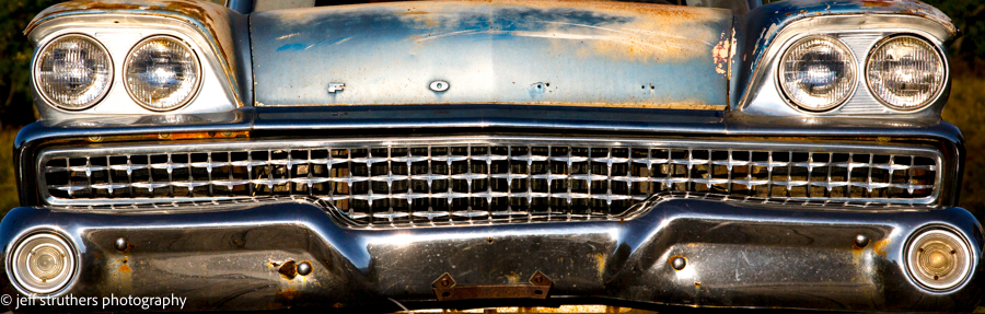 A close up of the front grill on an old car.