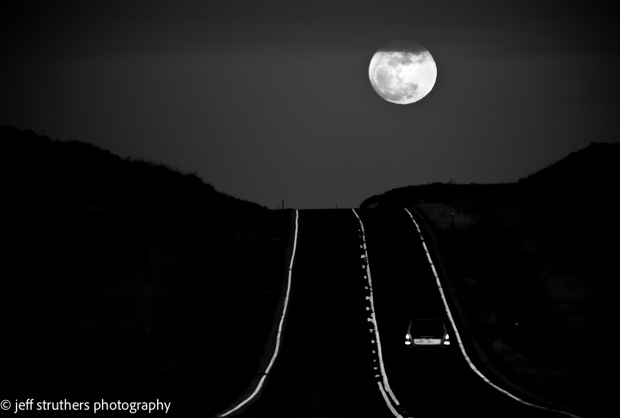 A train track with the moon in the background